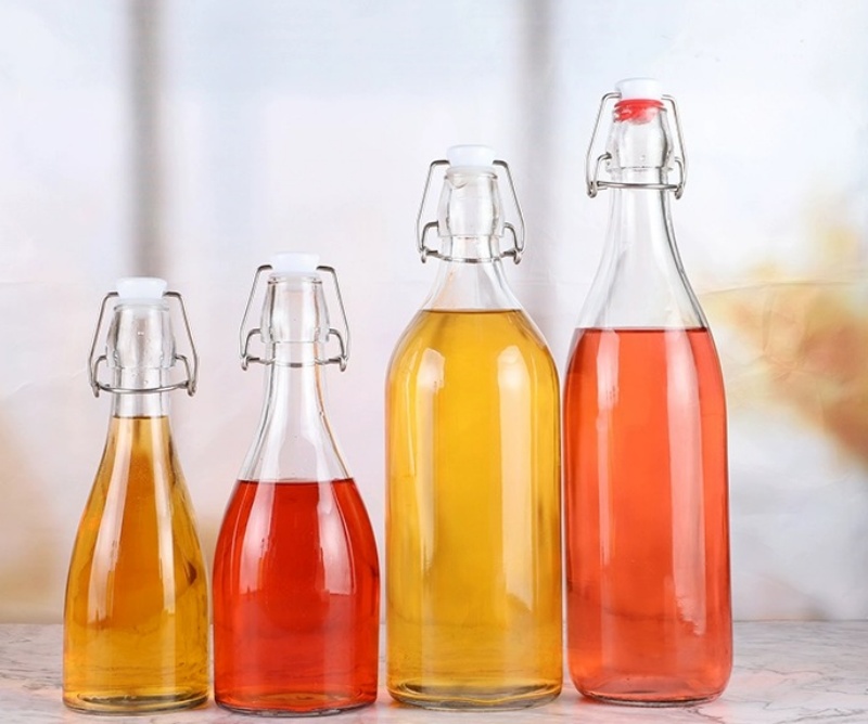 Empty Amber Round Wine Glass Bottle Customized Water Glass Bottle Fruit Wine Bottle With Swing Top Lid